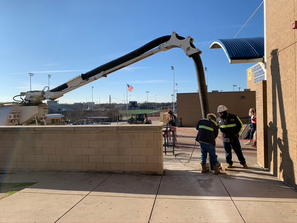 1-A Services crew operating a vac truck on a commercial job site