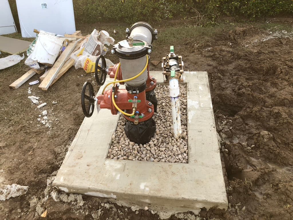 New RPZ backflow preventer installed on a concrete pad